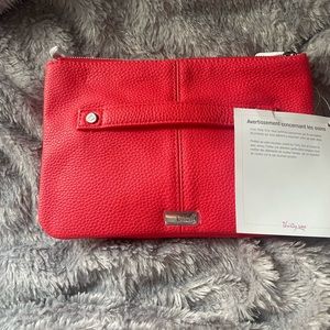 Brand new, with tags Thirty-one clutch.